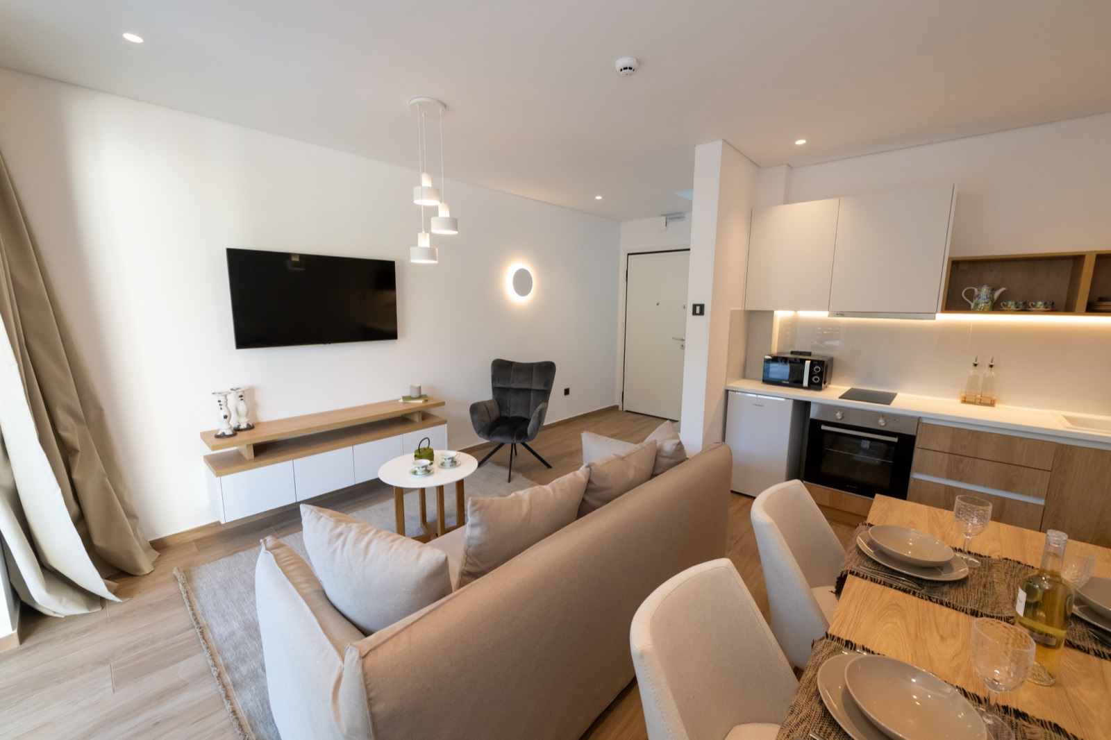 Bright open-plan living, kitchen and dining interior of a delivered villa
