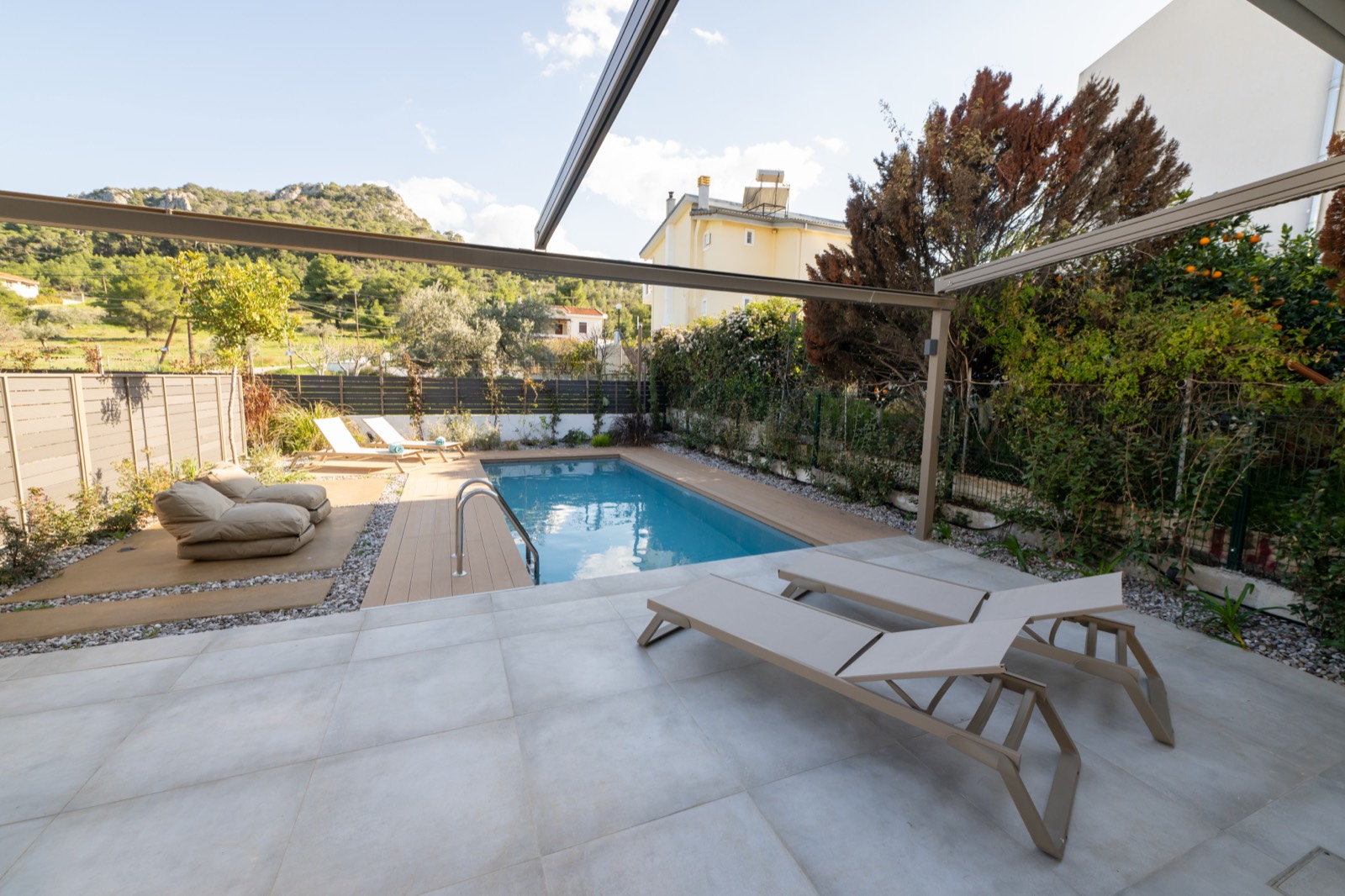 Pool terrace with sun loungers framed by the surrounding hills